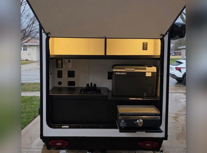 RV rental outdoor kitchen: sink, Euhomy fridge, pull-out griddle. Compact setup for camping adventures. — photo 14