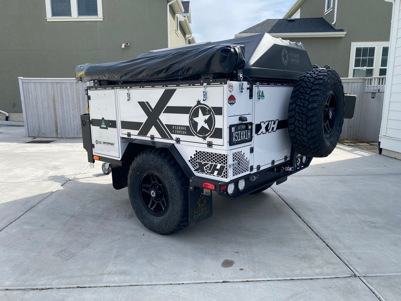 Rear view of a white Patriot Campers X1H off-road expedition trailer. Perfect for an outdoor RV rental adventure.