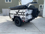 Rear view of a white Patriot Campers X1H off-road expedition trailer. Perfect for an outdoor RV rental adventure.