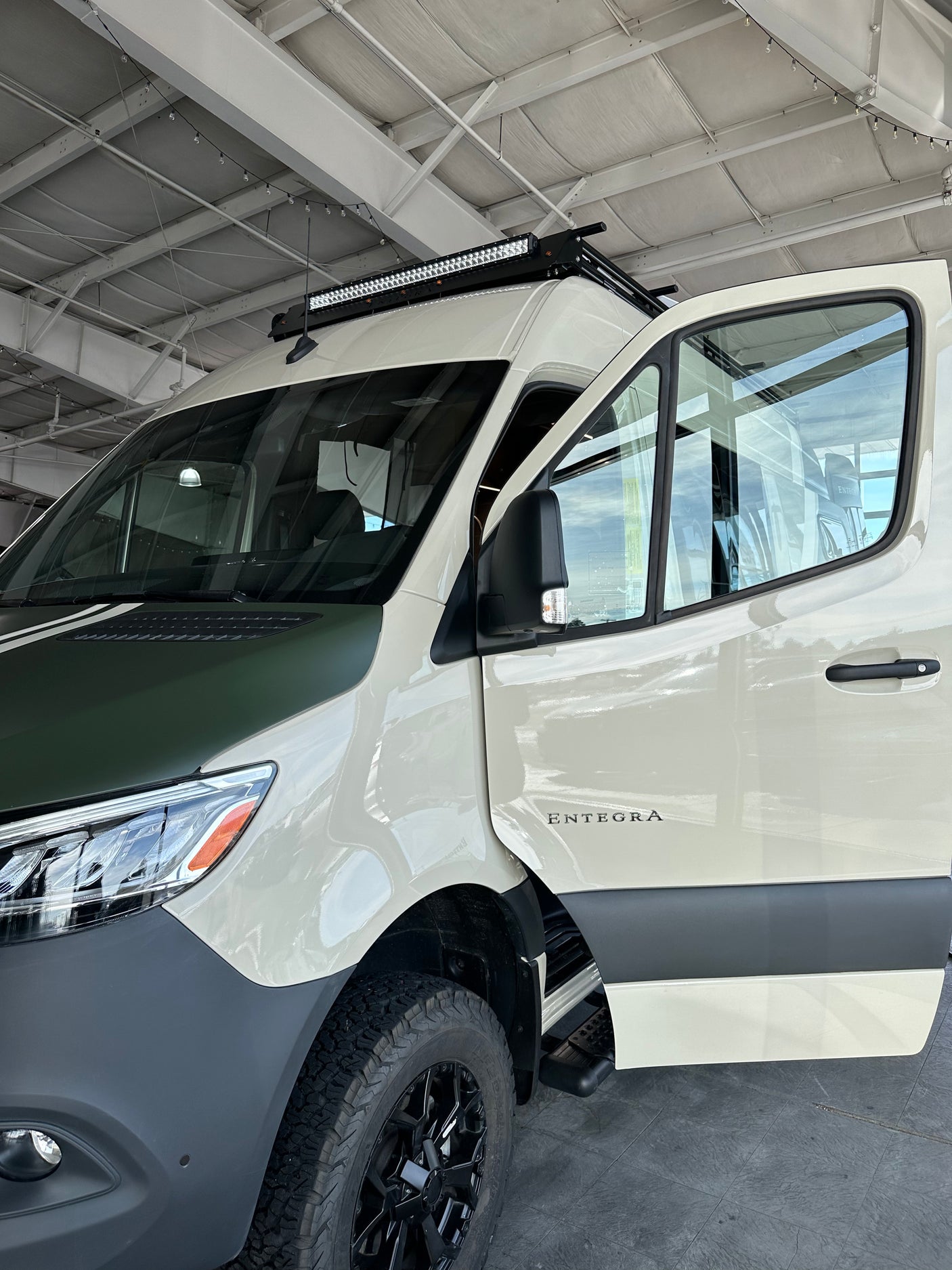 Explore with this customized Entegra camper van, perfect for rv rental. Notice the off-road tires & roof light bar.