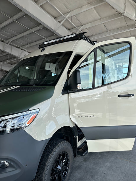 Explore with this customized Entegra camper van, perfect for rv rental. Notice the off-road tires & roof light bar.