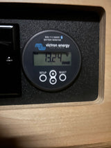 This Victron BMV-712 Smart Battery Monitor shows 13.24V, essential for managing power in your RV rental.