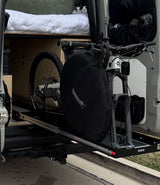 RV rental: Mountain bike stored securely on a rear pull-out tray in this camper van, ready for your next adventure.