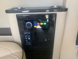 Close-up of a luxury RV rental's custom entertainment panel, featuring a Fusion stereo, Apple TV, HDMI, and USB.
