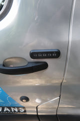 RV rental silver vehicle door with black handle & keypad (1-0) for keyless entry.