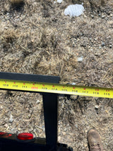 Measuring an RV rental component with a tape measure, showing inches from 109 to 119 on a metal beam.