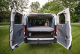 Open rear doors of a white camper van conversion, ready for your RV rental adventure with a bed and storage. Perfect for travel!