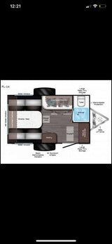 Top-down view of an FL-14 RV rental floor plan, highlighting the compact travel trailer interior: convertible bed, kitchen, bath, & storage.