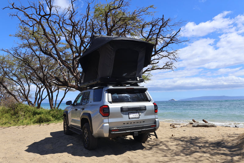  perfect for an outdoor camping adventure.|Explore beach camping with this RV rental: a silver Toyota 4Runner featuring a rooftop tent — photo 3