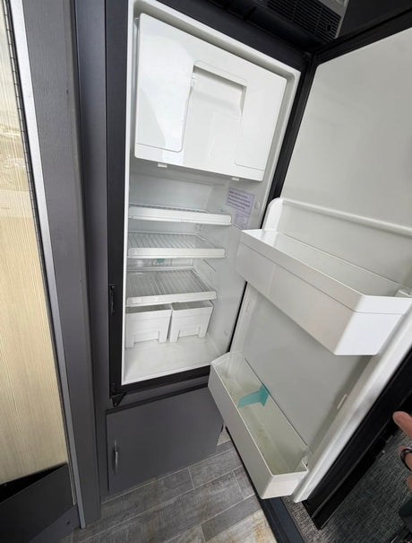 Empty & clean RV refrigerator, ready for stocking on your rv rental journey.