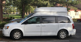 White high-top camper van, possibly for RV rental, parked. Ideal for travel & adventure.