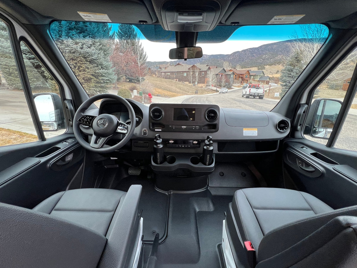 Inside a modern rv rental van: driver's view of dashboard, steering wheel, seats, and a scenic road ahead. — photo 8