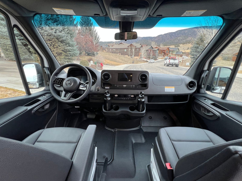 Inside a modern rv rental van: driver's view of dashboard, steering wheel, seats, and a scenic road ahead. — photo 8
