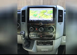 Inside an RV rental: detailed dashboard with a large navigation screen showing a map, climate controls, and gear shifter.