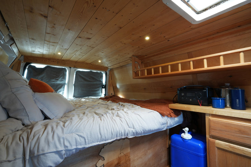 Experience van life in this cozy RV rental with wooden interior, comfy bed, and off-grid power. — photo 5