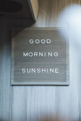 "Good Morning Sunshine" letter board on a light wood wall, for a bright start in your cozy RV rental.