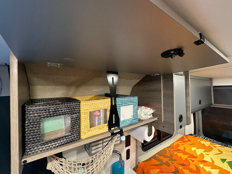  featuring a compact kitchen with a pot and supplies.|RV rental: Ram ProMaster van interior — photo 12