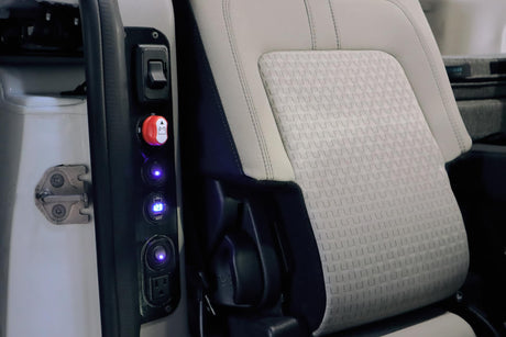 RV rental interior panel shows multiple power outlets (AC, USB), battery switch, and voltage display next to a passenger seat.