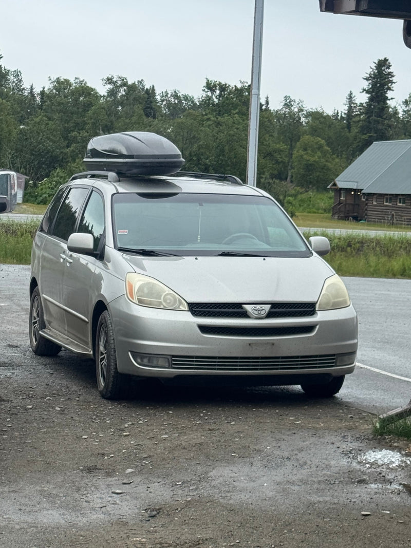 Silver minivan with a roof box — photo 1