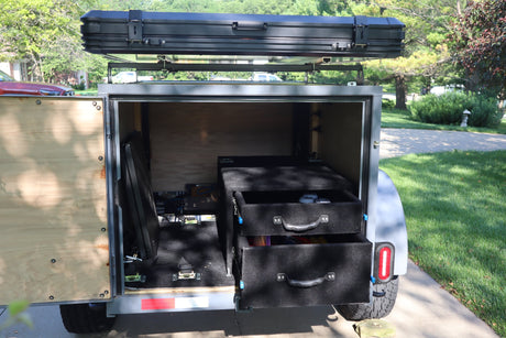  is ready for adventure.|Overland RV rental trailer with rooftop tent deployed
