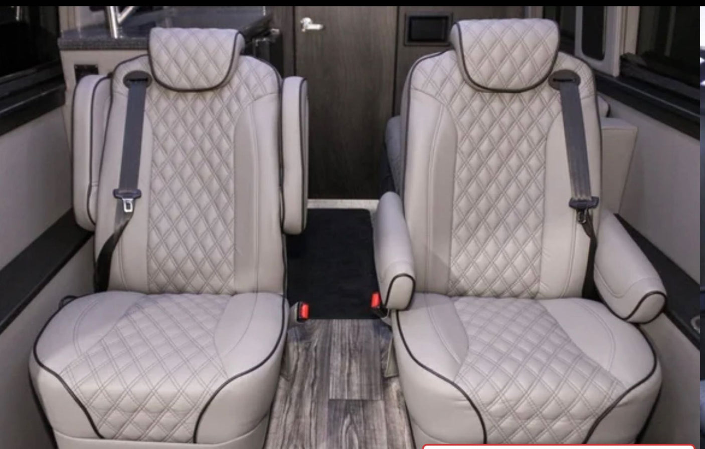 Plush, diamond-quilted captain's chairs in an RV rental interior, offering comfort for passengers.