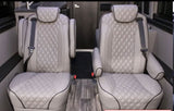 Plush, diamond-quilted captain's chairs in an RV rental interior, offering comfort for passengers.