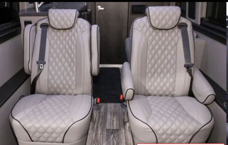 Plush, diamond-quilted captain's chairs in an RV rental interior, offering comfort for passengers.