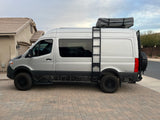 This customized silver Sprinter van with a rooftop tent is ready for your next RV rental adventure.
