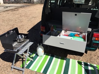  overlooking scenic desert.|RV rental interior: comfy gray bench seat with under-seat storage — photo 3