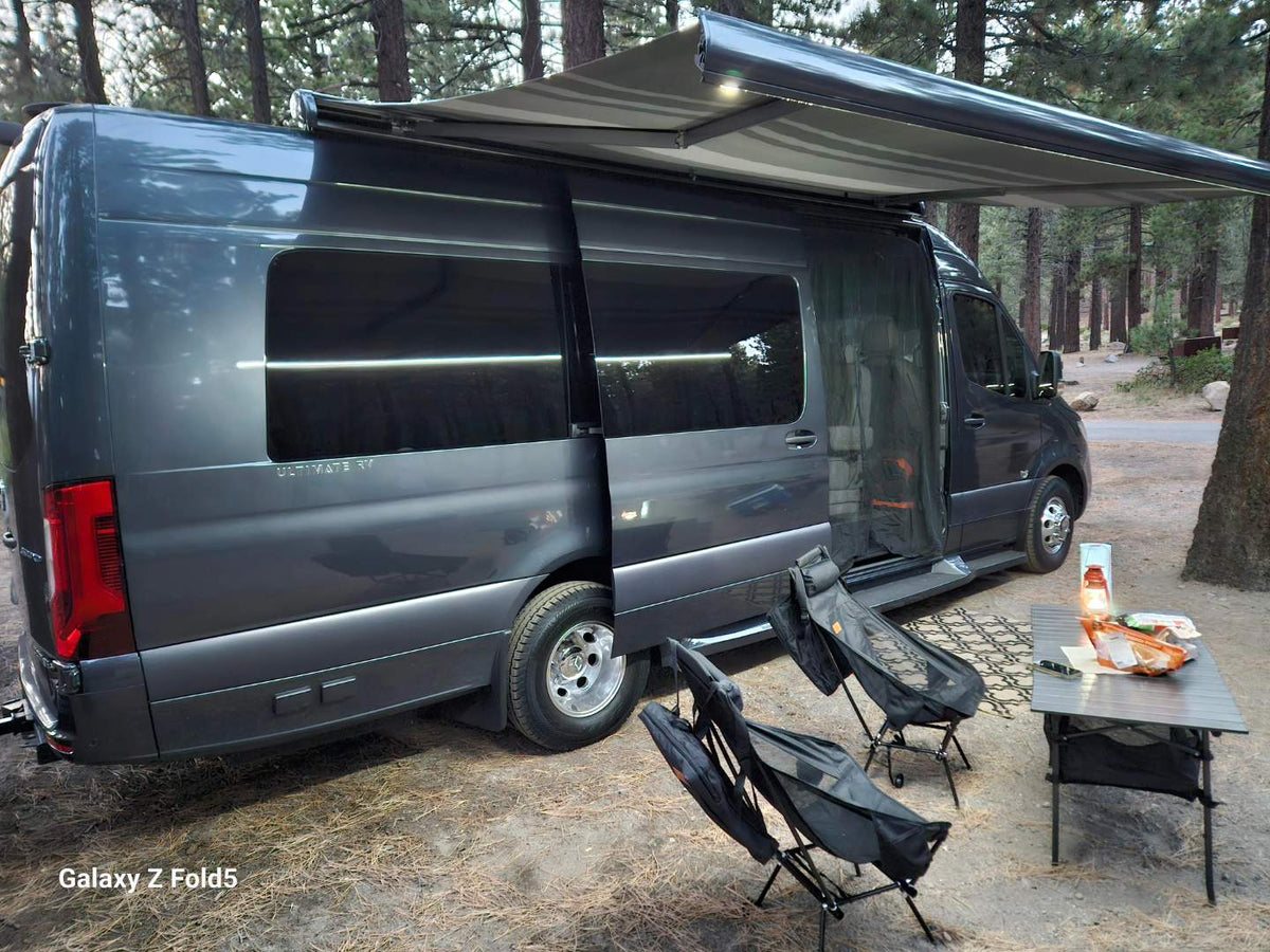  and wood floors for comfortable travel.|Interior of a modern RV rental. Features a compact kitchen with sink