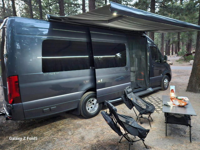  and wood floors for comfortable travel.|Interior of a modern RV rental. Features a compact kitchen with sink