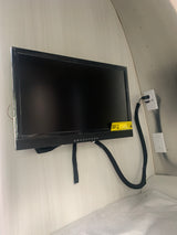 Wall-mounted TV and power outlets inside an RV rental, providing entertainment and convenience in a compact space.