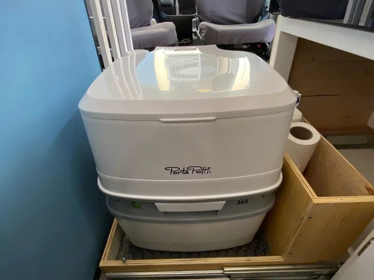 Essential white Porta Potti portable toilet in an RV rental, ensuring comfortable travel and sanitation. — photo 18