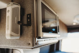 RV rental interior detail: Mounted Furrion speaker, USB ports, and compact microwave for convenient living.