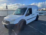 A white Ford Transit Connect, part of a local rental fleet offering rv rental, sits by a Hawaii marina.