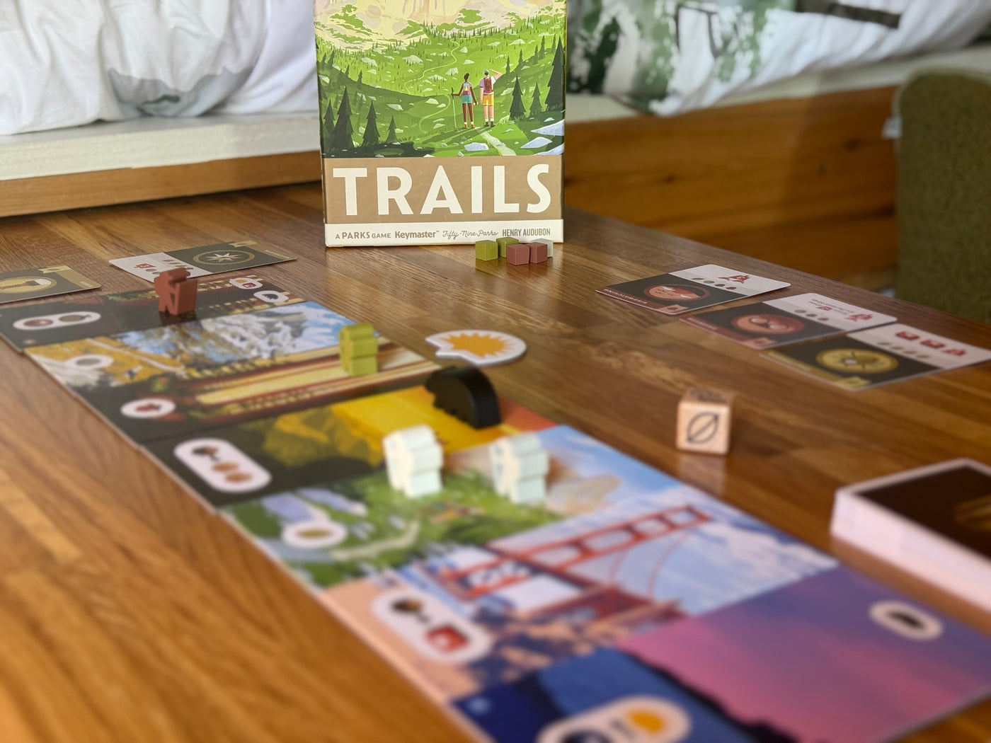 "TRAILS: A Parks Game" set up on a wooden table, an ideal leisure activity for an RV rental getaway. — photo 9