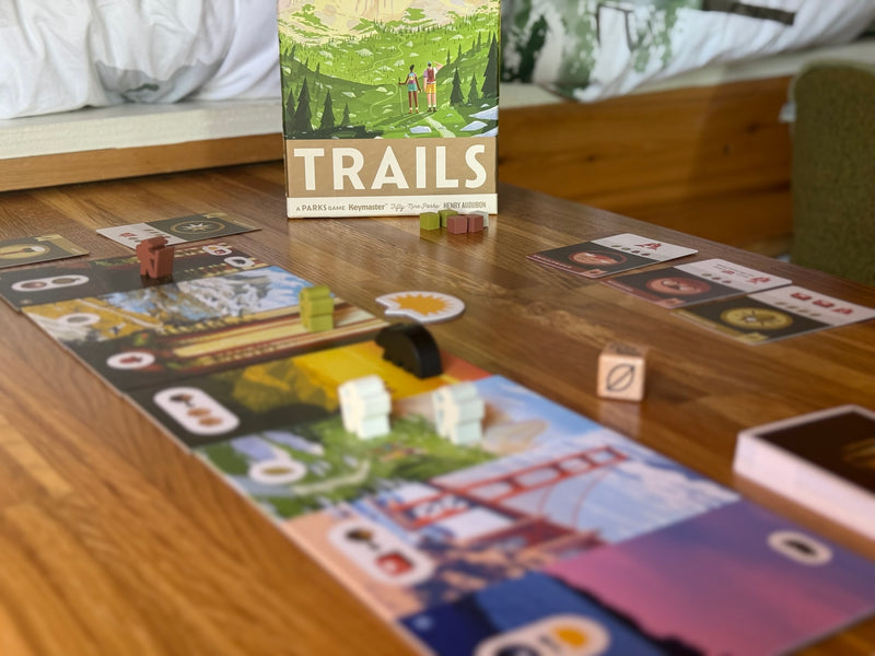 "TRAILS: A Parks Game" set up on a wooden table, an ideal leisure activity for an RV rental getaway. — photo 9