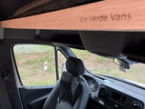 Inside an RV rental van: driver's area, dashboard, and a branded overhead beam reading "Via Verde Vans." Ideal for travel.
