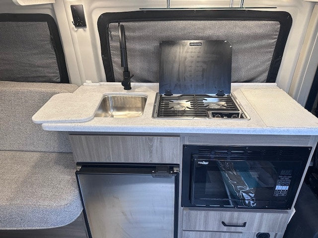  and clear dashboard controls.|Spacious RV rental interior: modern kitchenette — photo 3