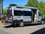 Silver Sequence rv rental van with bikes, generator, and awning. Ready for your next outdoor adventure!