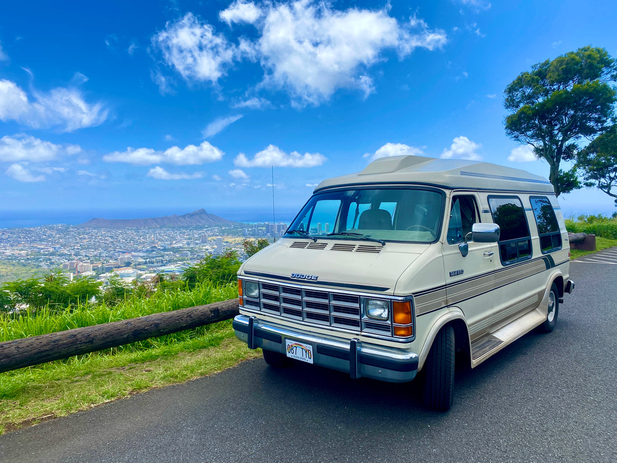 Scenic Hawaii RV rental: A vintage Dodge van parked on a road overlooking Honolulu's cityscape and Diamond Head on a sunny day. — photo 3