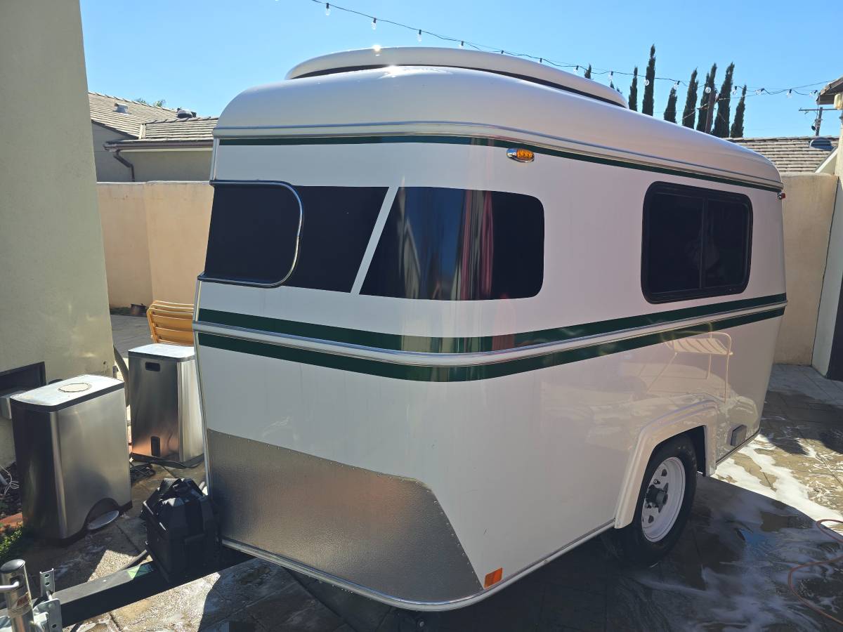  sparkling clean.|Compact white travel trailer with green stripes — photo 5
