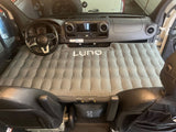 RV rental: Inflated Luno air mattress transforms a Mercedes Sprinter van's front cabin into a cozy sleeping area for travels.