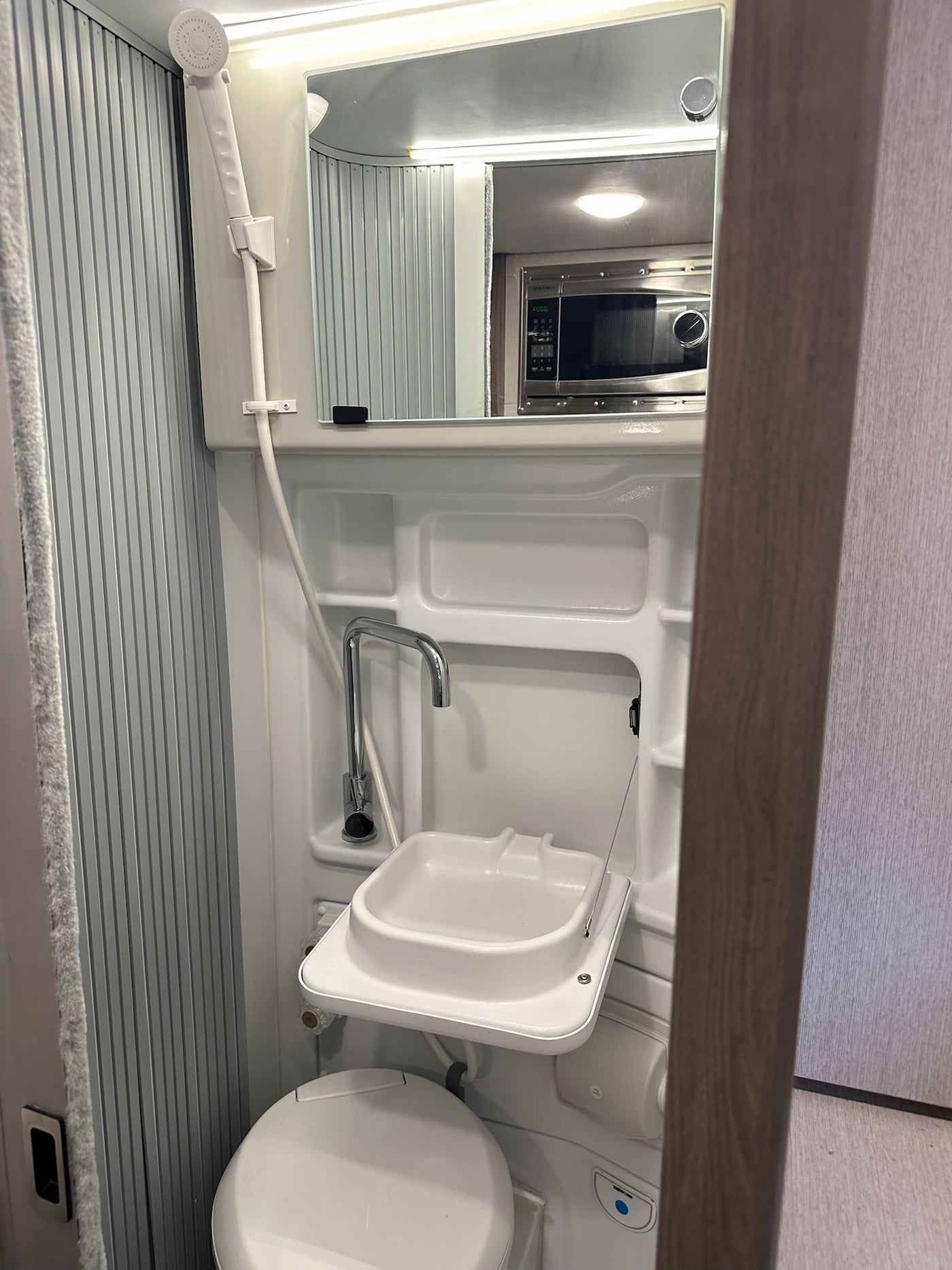  and adjacent bed area.|RV rental: Camper van's cozy interior features a bed — photo 6