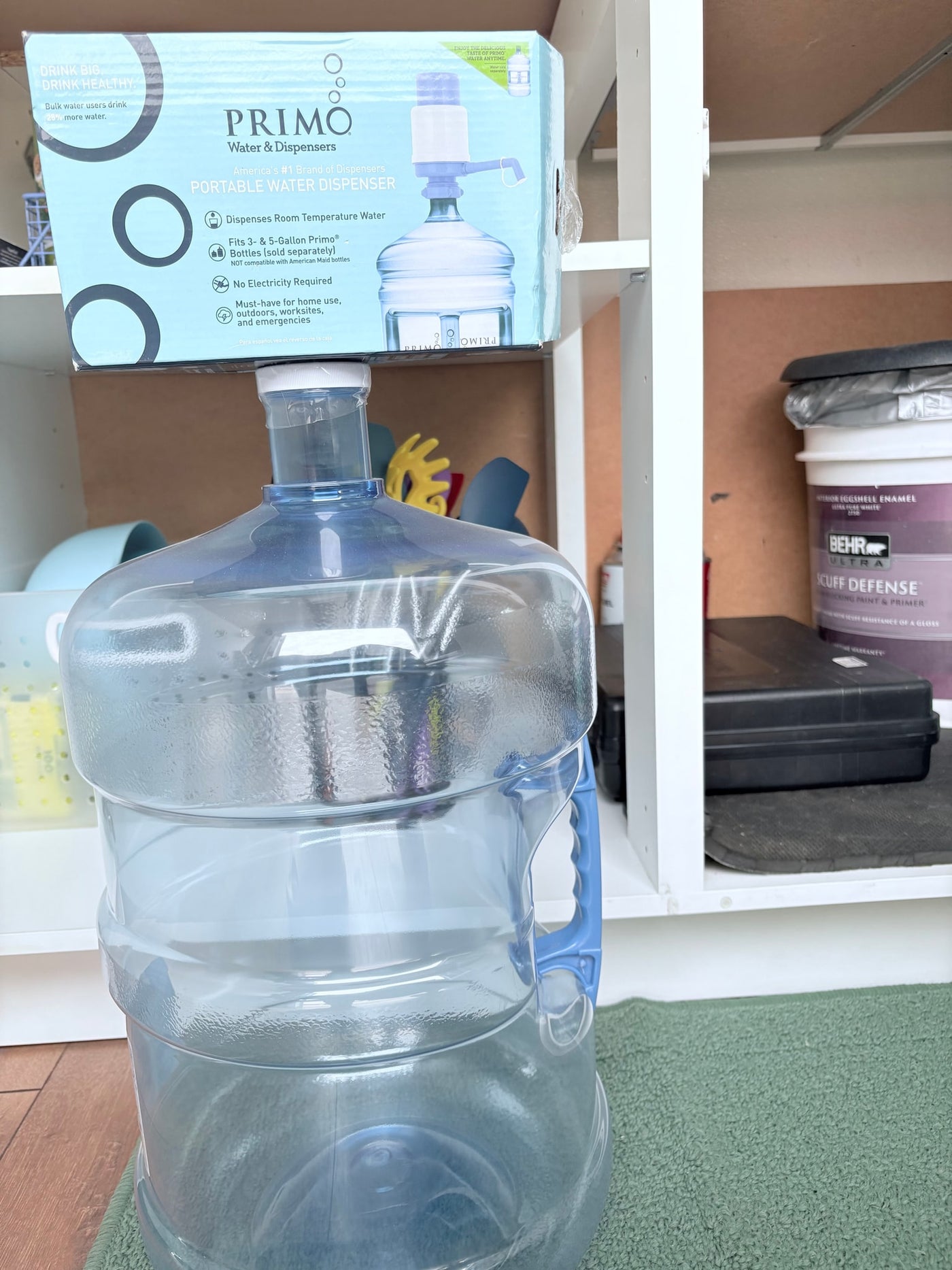 A Primo portable water dispenser box sits on an empty 5-gallon bottle, highlighting its utility for an RV rental or outdoor use with no electricity needed. — photo 11