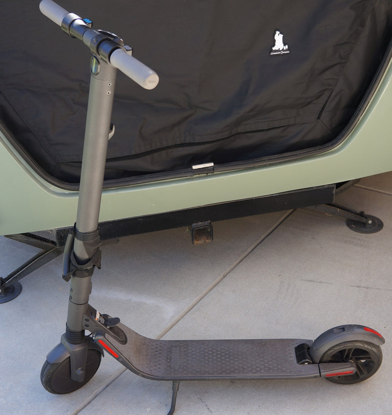 An electric scooter is parked near an RV rental, a Happier Camper, for convenient exploration. — photo 17