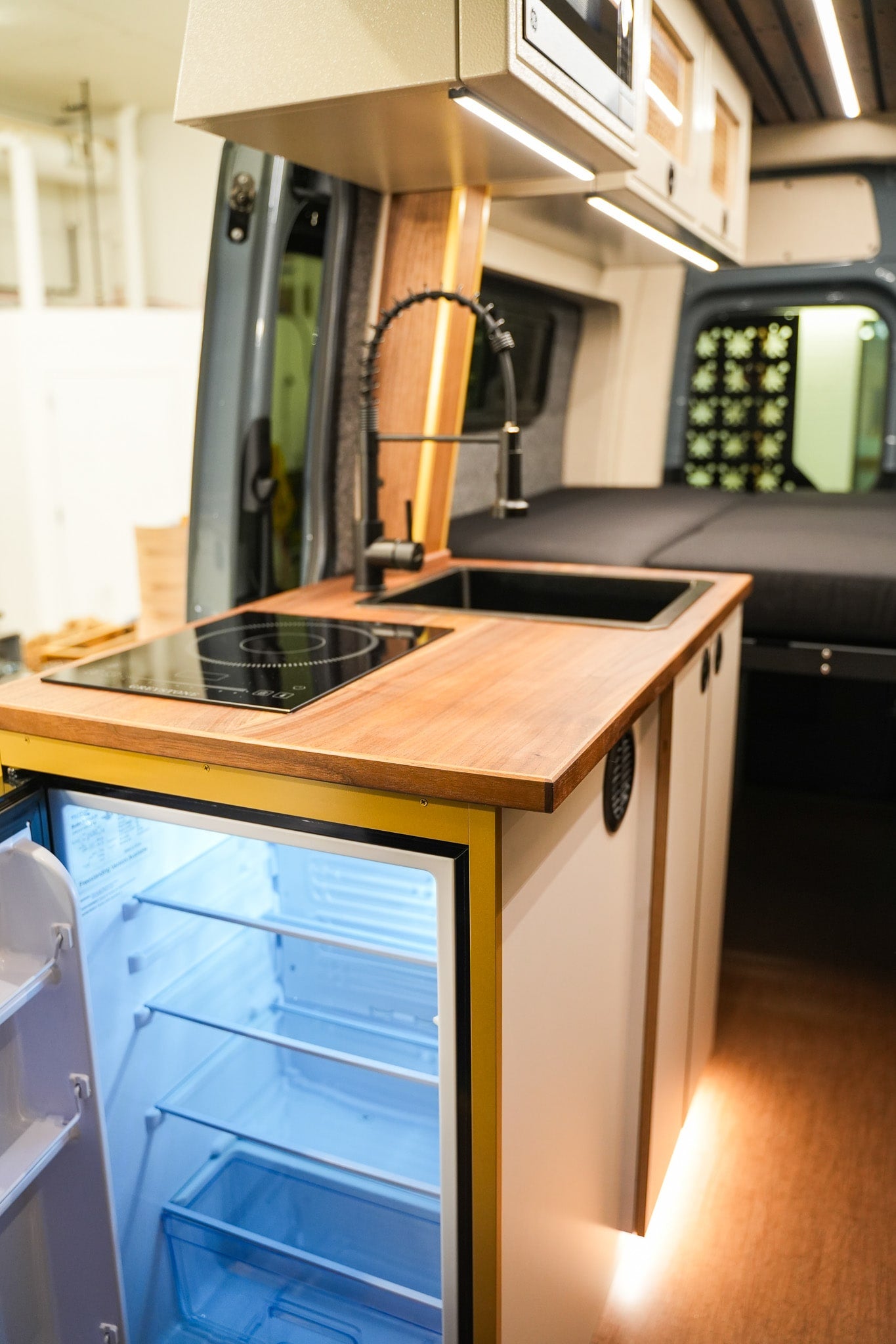  and a control panel for mobile living.|A stunning blue custom Sprinter camper van for rv rental — photo 2
