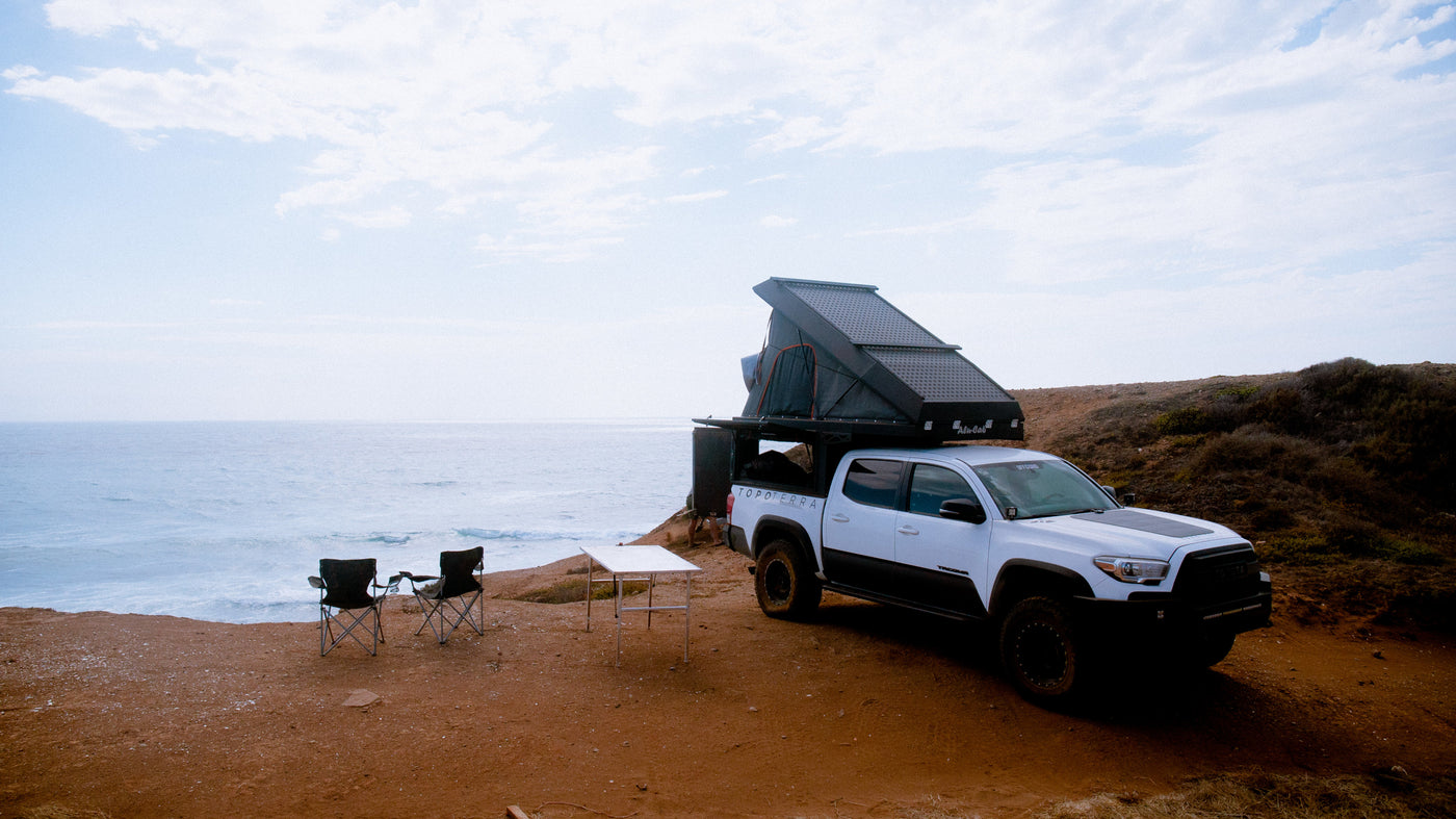 RV rental adventure: White Toyota Tacoma truck camper and campsite setup by the ocean. Ideal for overlanding. — photo 3
