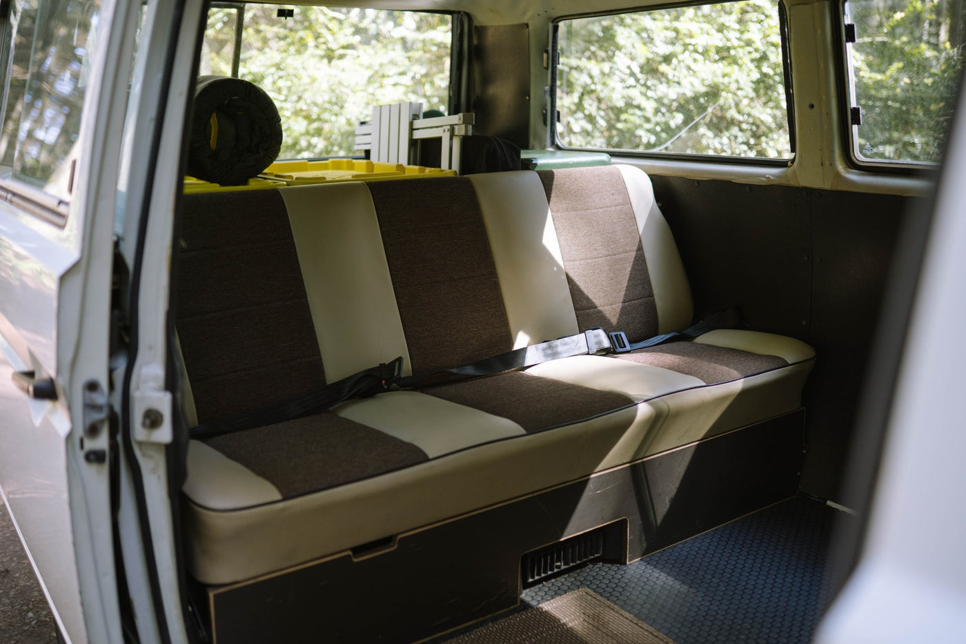  with a bed laid out and front seats visible. Ideal for an RV rental adventure.|Step inside this cozy VW van! A detailed view of the driver's seat — photo 8