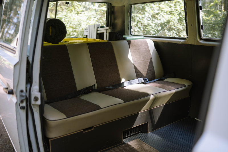  with a bed laid out and front seats visible. Ideal for an RV rental adventure.|Step inside this cozy VW van! A detailed view of the driver's seat — photo 8